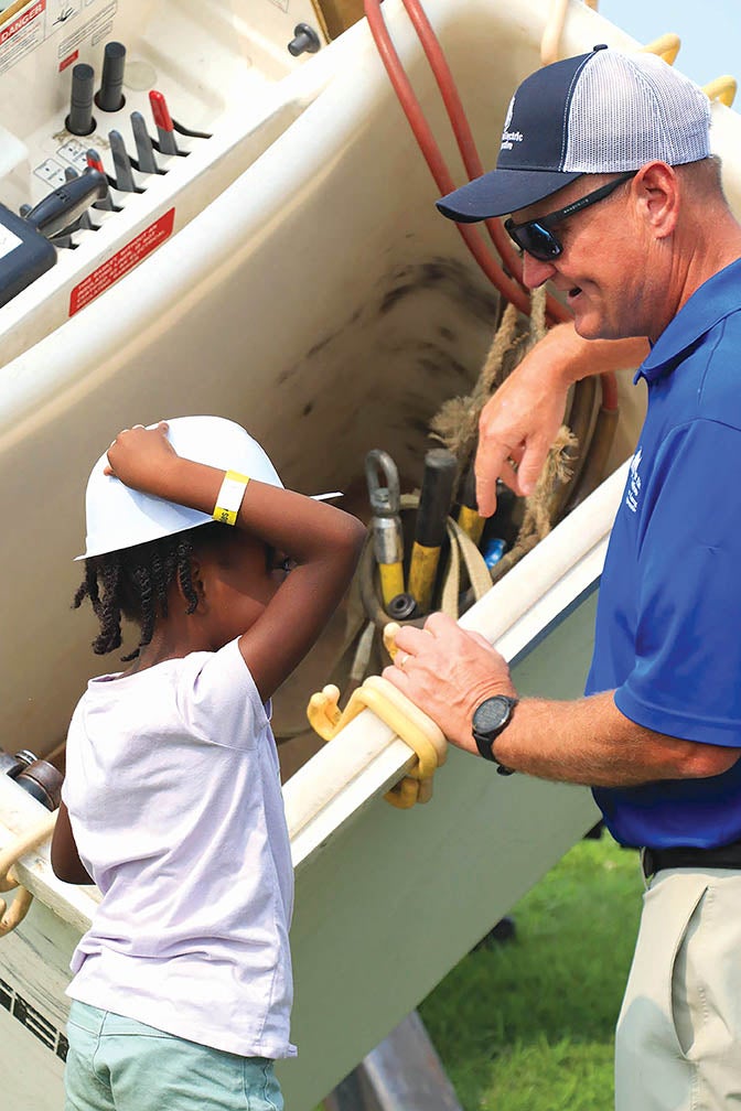 Filewicz familiarizing a child with the tools of the trade.